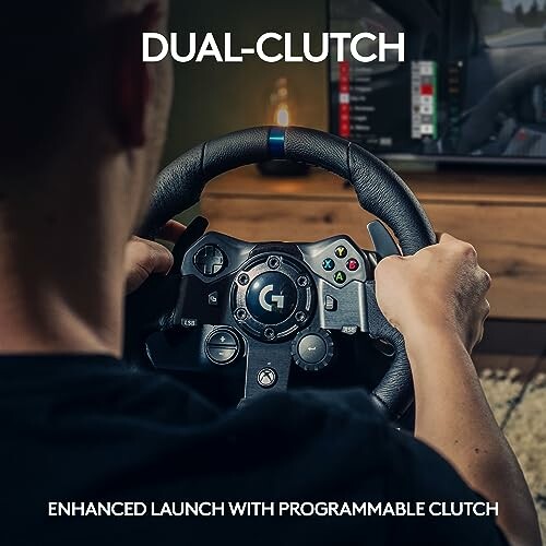 Person using a racing simulator steering wheel with dual-clutch feature.