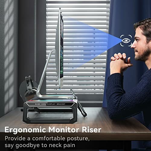 Man using an ergonomic monitor riser at a desk