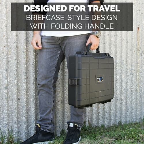 Person holding a briefcase-style case with folding handle, designed for travel.